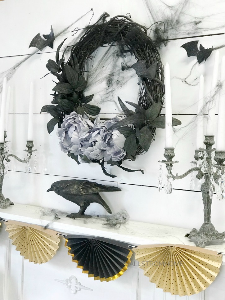 #1 Halloween Wreath that's Easy Elegant and Beautiful black wreath above mantel with crow and 2 candelabras with fan banner