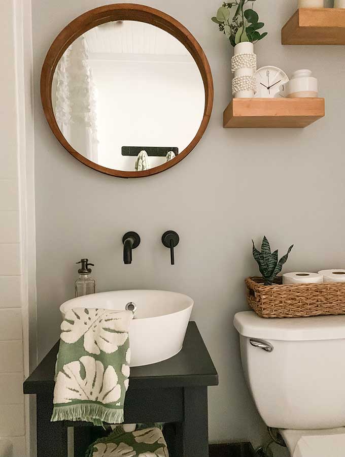 Small Bathroom Makeover Ideas|guest bathroom|powder room|paint color|bathroom makeovers|small bathroom makeover|small bathroom|storage space|bathroom remodels|before and after|pedestal sink|earth elements|bathroom faucet|delta faucets|sponsored|sink faucet|floor tiles|Hallstrom Home