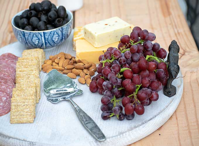 How to Use a Charcuterie Board for Entertaining|outdoor entertaining|how to assemble cheese board|cheese platter presentation|cheese platter appetizer|Farmhouse dining|outdoor dining|veranda|party planning|appetizer recipes|best recipes|party recipes|entertaining recipes|hallstrom home