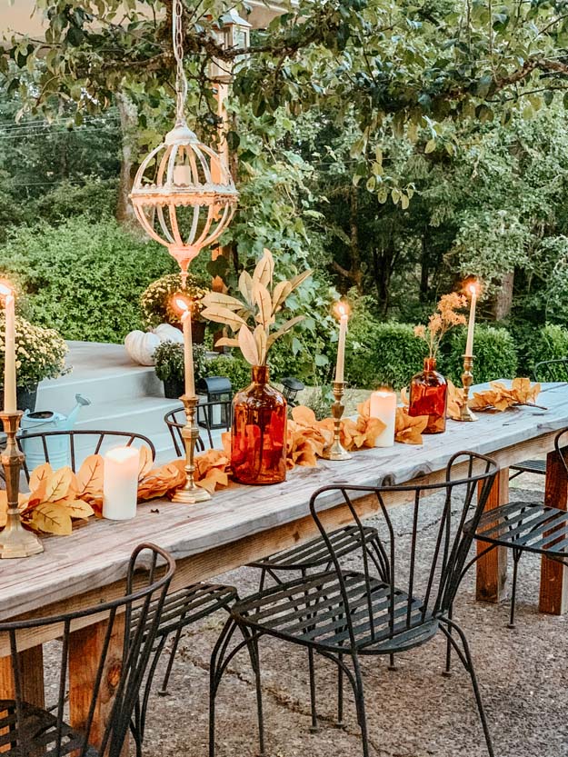 Outdoor Fall Tablescape with Leaves |fall table settings|farmhouse table|fall farmhouse table|farmhouse decor|fall leaves|fall leaf diy|outdoor tablescape|fall table settings|amber jars|fall centerpiece|amber fall decor|fall diy|fall craft|Hallstrom Home