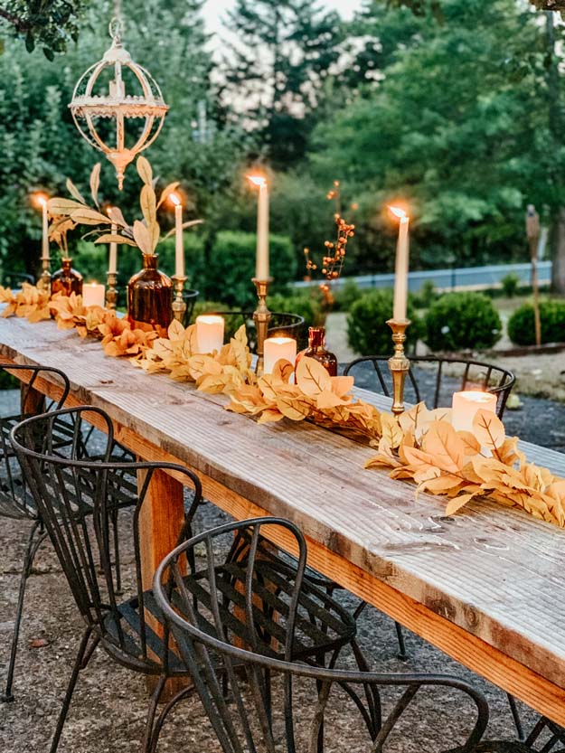 Outdoor Fall Tablescape with Leaves |fall table settings|farmhouse table|fall farmhouse table|farmhouse decor|fall leaves|fall leaf diy|outdoor tablescape|fall table settings|amber jars|fall centerpiece|amber fall decor|fall diy|fall craft|Hallstrom Home